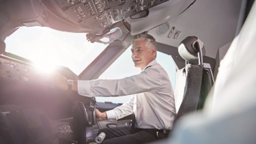 A pilot is sitting in a cockpit.