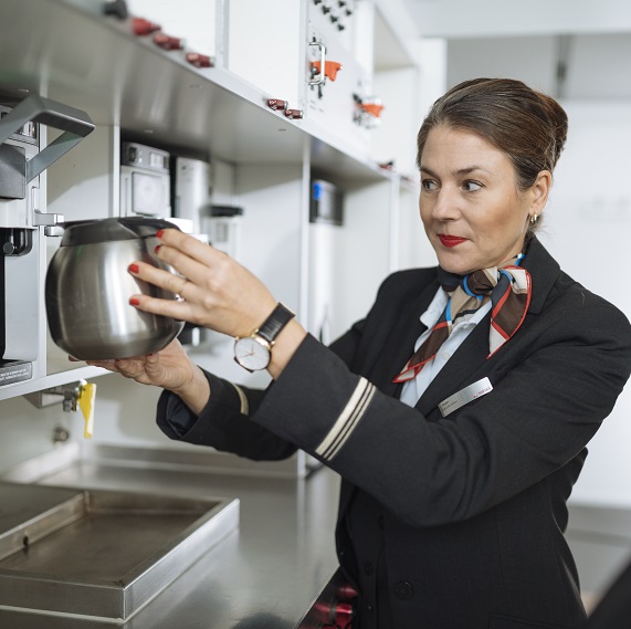 A flight attendant in a galley mock-up