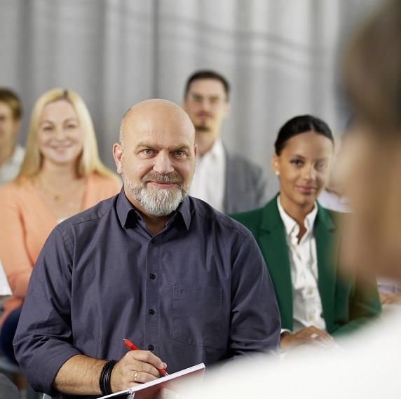 Several people are listening to a presentation